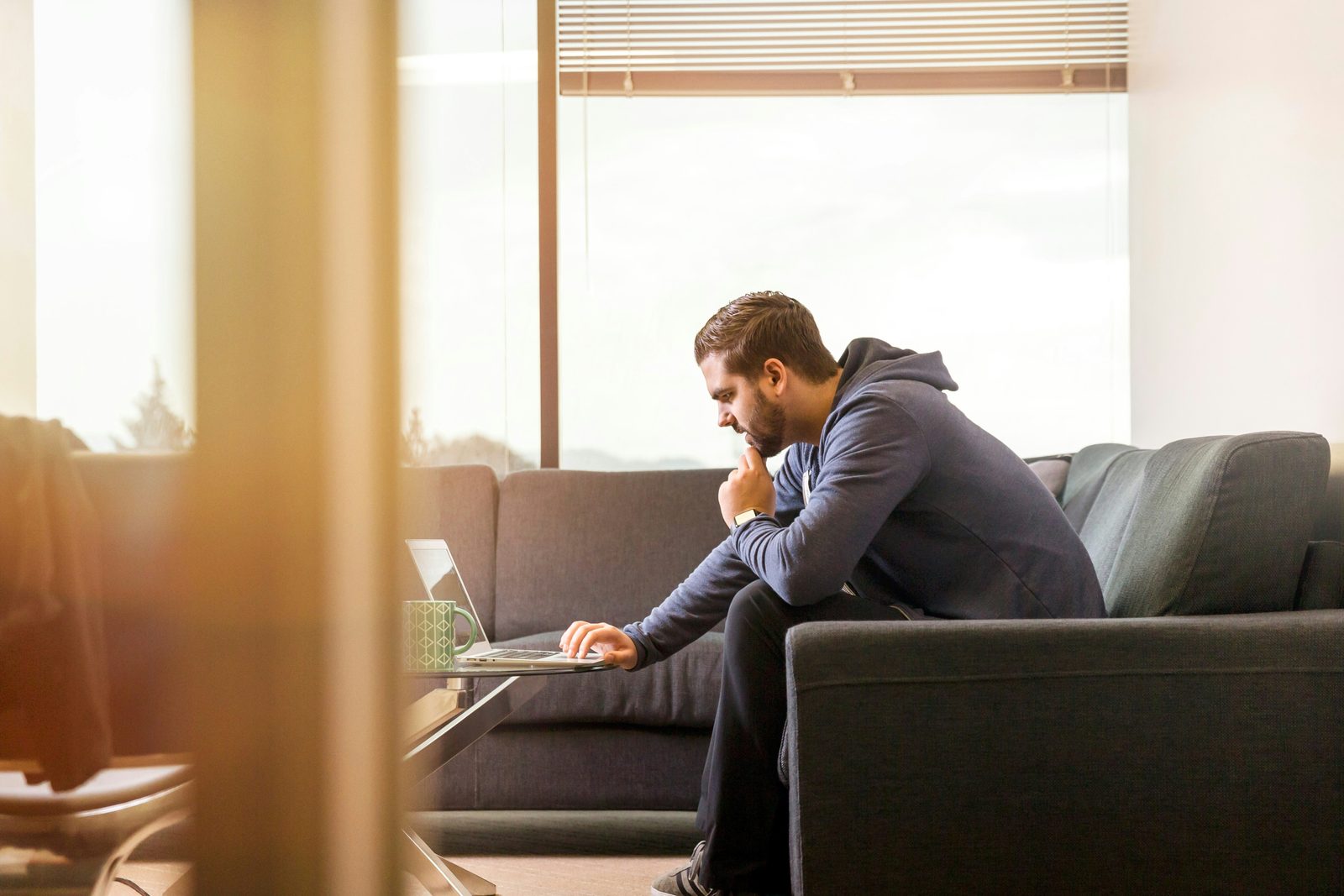 A man speaking openly on his laptop during an online anger management therapy session in Ontario