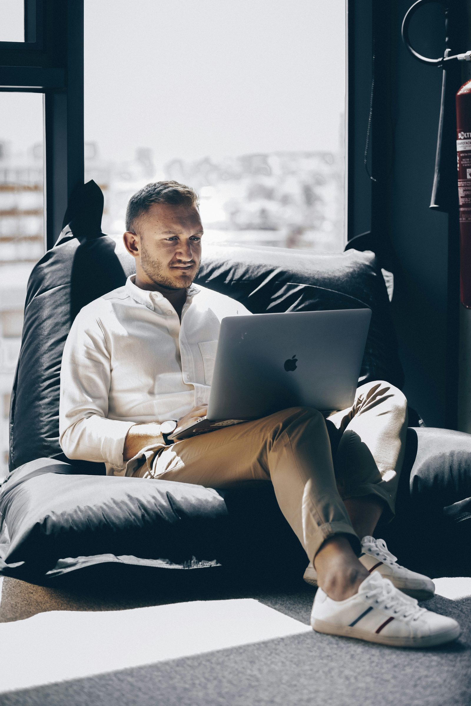 A man at home on his laptop during a relaxed first online therapy consultation in Ontario