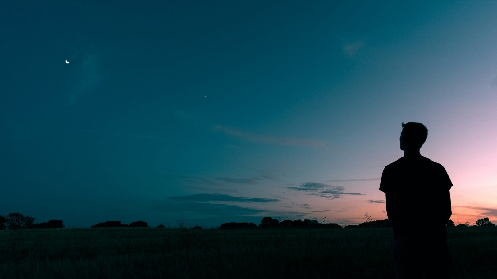 A man sitting in thought, weighing whether to reach out for help, men's therapy in Ontario